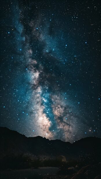 Space iPhone HD wallpaper with a breathtaking view of the Milky Way galaxy from a dark desert landscape, stars shining brightly.