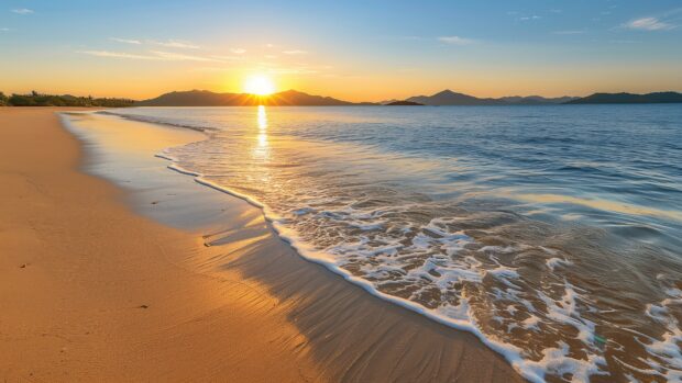 A Fiji beach HD desktop wallpaper with gentle waves and golden sand, the sun setting behind distant islands.