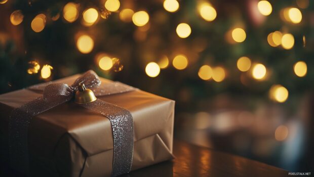 A close up of a beautifully wrapped gift with a ribbon and a bell, Christmas 1920x1080 Wallpaper.