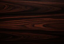 A dark ebony wood wallpaper with deep, rich colors and fine grain.