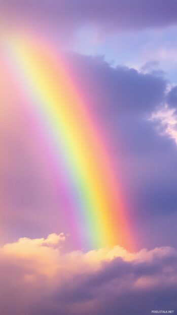 A delicate pastel rainbow stretching across a light, cloudy sky with soft.