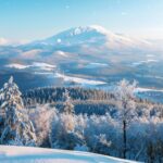 A winter mountain range under a clear blue sky, iphone background.