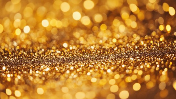 Bright golden glitter wallpaper 4K with a vibrant sparkl.