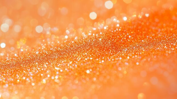 Bright orange glitter background with a lively, energetic sparkle.