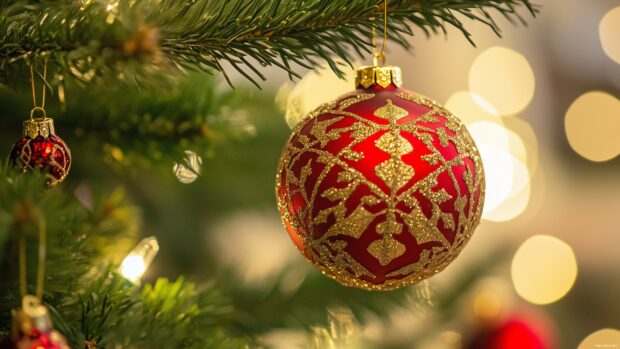 Christmas Wallpaper 4K with a close up of a red and gold ornament hanging on a Christmas tree branch.