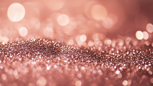 Elegant rose gold glitter background with a soft, shiny glow.