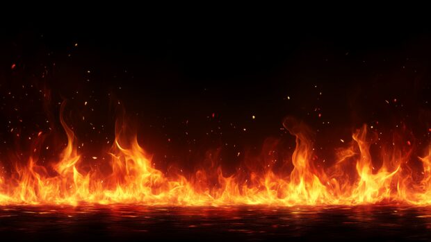 Fire wallpaper 4K with a dramatic wall of red flames with varying intensity, set against a pure black background.