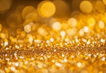 Glitter background HD in golden hues with a dazzling effect.