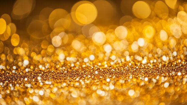 Glitter background HD in golden hues with a dazzling effect.