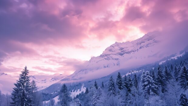 Pink winter dawn over a snowy mountain range, 4K Winter Wallpaper.