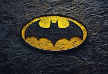 The classic Batman logo 4K in bright yellow and black.