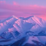 Winter HD Desktop Wallpaper with pink winter dawn over a snowy mountain range.