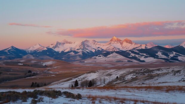 Winter Landscape Desktop HD Wallpaper with sunset casting pink and orange hues over snowy mountains.