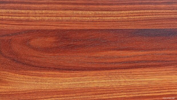 Wood desktop background with a polished mahogany wood surface with rich, deep brown hues.