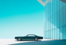 1080p full HD background with a luxury car parked in front of a modern glass building under a clear blue sky.