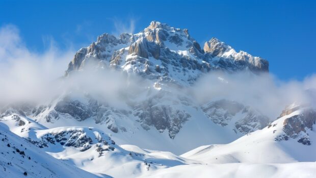 1920×1080 HD Wallpaper features a snowy mountain peak with a clear, crisp winter sky.