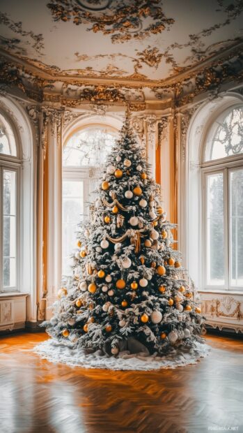 A Christmas tree with elegant white and gold decorations in a grand living room, phone wallpaper.