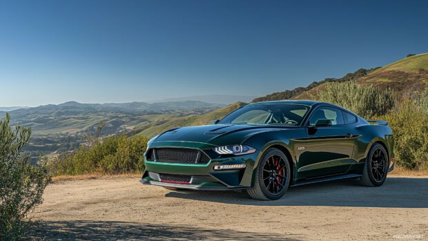 A Ford Mustang Bullitt in dark green, showcased in a scenic countryside setting with rolling hills and a clear blue sky.