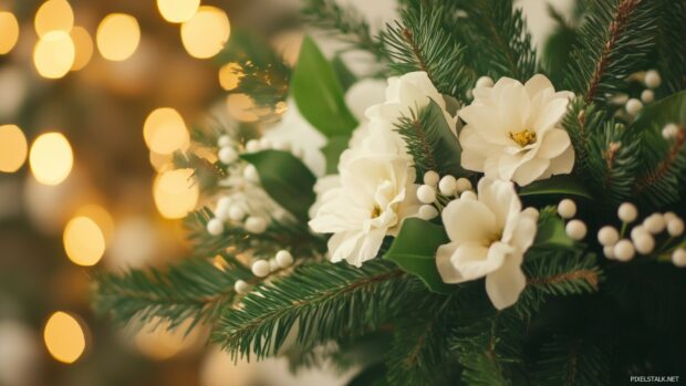 A beautiful arrangement of pine branches and white flowers on a table.