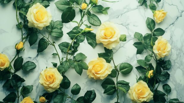 A beautiful composition of yellow roses intertwined with green leaves, arranged artistically on a marble surface.