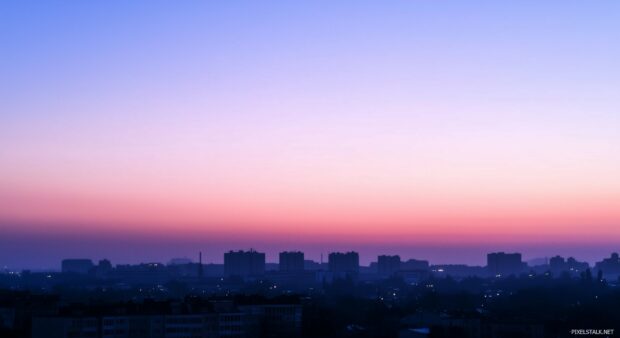 A beautiful view of a cityscape at twilight, with subtle silhouettes of buildings and a gradient sky.