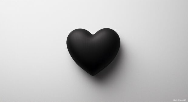 A bold, solid black heart centered on a soft white background, with a slight shadow effect.