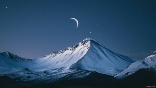 A breathtaking view of a snow Mountain glowing under the soft light of the moon.