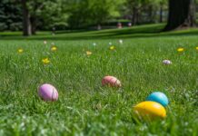 A cheerful Easter Background with colorful eggs scattered in a meadow, with vibrant flowers and green grass, bright spring sunshine.