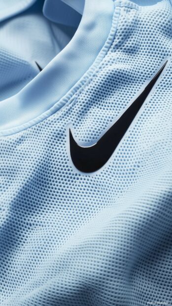 A close up of Nike blue athletic wear displayed on a seamless blue background.