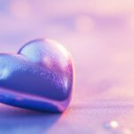 A close up of a shiny blue heart on a simple pastel background, with light reflections adding a sense of dimension and a modern touch.