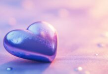 A close up of a shiny blue heart on a simple pastel background, with light reflections adding a sense of dimension and a modern touch.