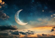 A crescent moon shining brightly amidst a sky full of twinkling stars, casting a soft glow over a peaceful landscape.