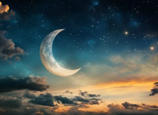 A crescent moon shining brightly amidst a sky full of twinkling stars, casting a soft glow over a peaceful landscape.