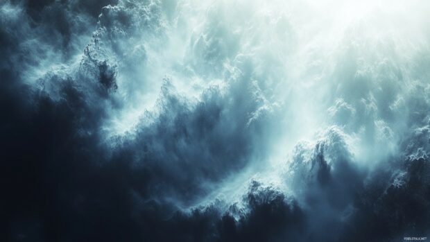 A dramatic snowy desktop wallpaper with swirling mist and sunlight breaking through.