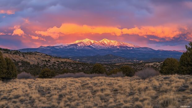 A dramatic view of the Rocky Mountains during sunset.