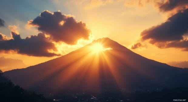 A lone Mountain silhouetted against a dramatic sunset.