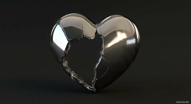 A metallic broken heart with a visible crack down.