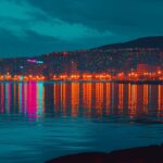 A night scene of a city waterfront 4K image with reflections of city lights dancing on the water.