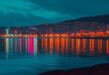 A night scene of a city waterfront 4K image with reflections of city lights dancing on the water.