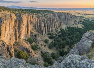 A panoramic view of the Rocky Mountains during sunrise.