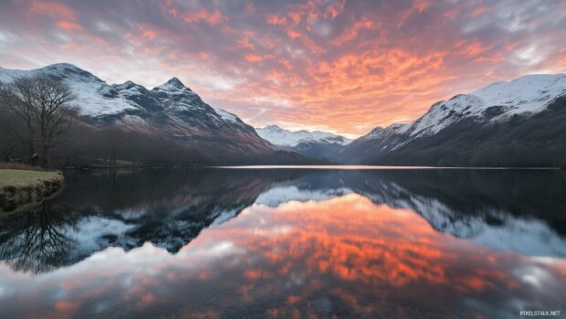 A picturesque mountain lake nestled between snow capped peaks.