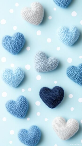 A playful arrangement of small blue hearts in various shades, set against a light blue polka dot background.