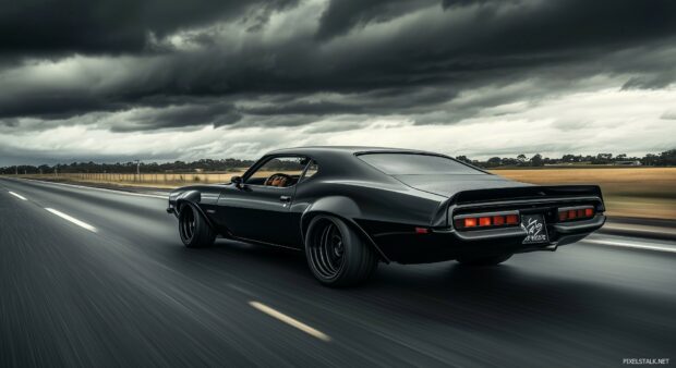 A powerful muscle Car PC Wallpaper with its engine roaring on a deserted highway under stormy skies.