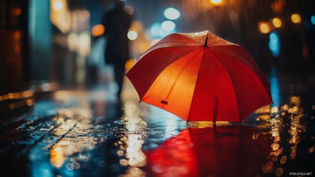 A rainy evening in the city with reflections on wet pavement and umbrellas dotting the streets.