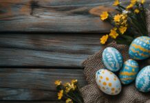 A rustic Easter arrangement with painted eggs, burlap, and spring flowers on a wooden surface, cozy atmosphere.