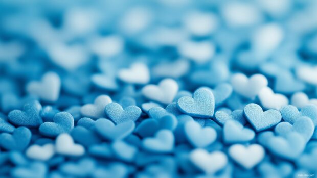 A scattered pattern of small blue hearts in various shades, set against a gentle gradient background transitioning from light blue to white.