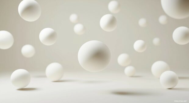 A series of floating 3D spheres gently rising and falling, creating a calm and rhythmic movement in a minimalist environment.