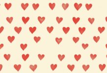 A simple pattern of small, red hearts 4K resolution evenly spaced on a light beige background.