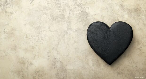 A single, textured black heart wallpaper.