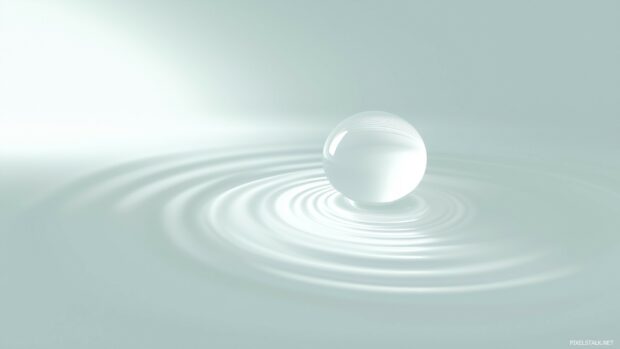 A single water droplet falling on a perfectly smooth surface with a light ripple effect, set on a pale blue background.